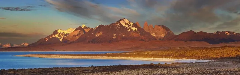 The vast deep blue waters of Lago Sarmiento with the jagged peaks of the Paine Massif in the distance.