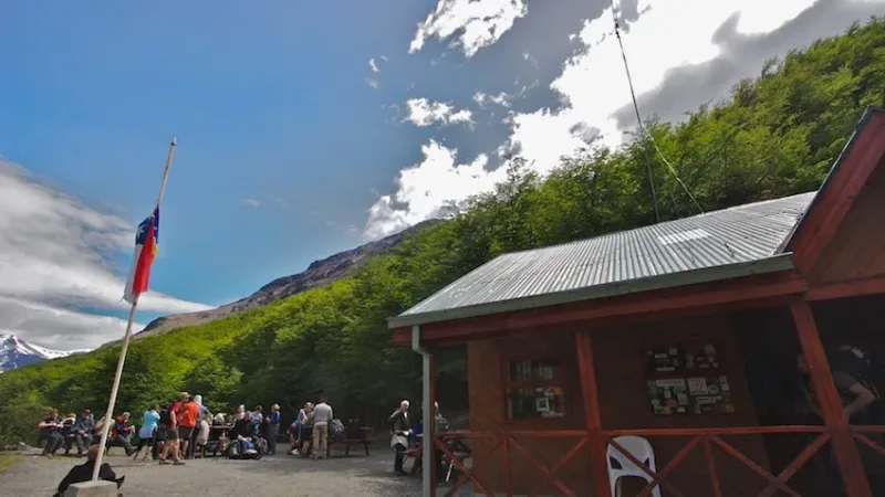 Rustic wooden exterior of the Cafetería Chileno nestled in the forested mountainside of the W trek.