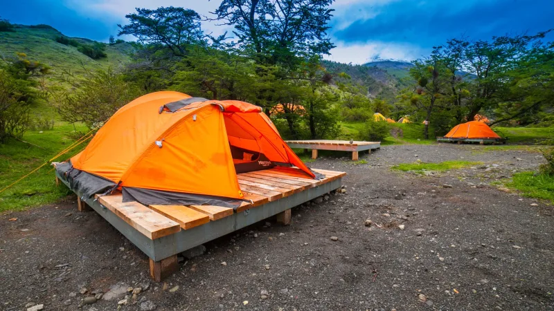 The narrow woodland path entering the quiet, shaded sites of the Torres campground.