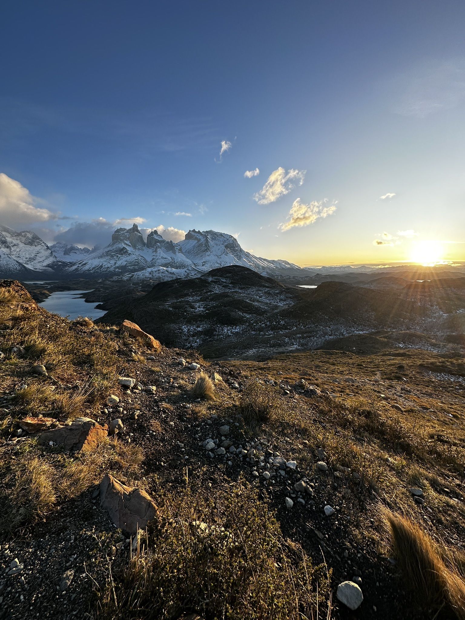 A panoramic view of turquoise lakes and jagged peaks from the elevated Mirador Condor.