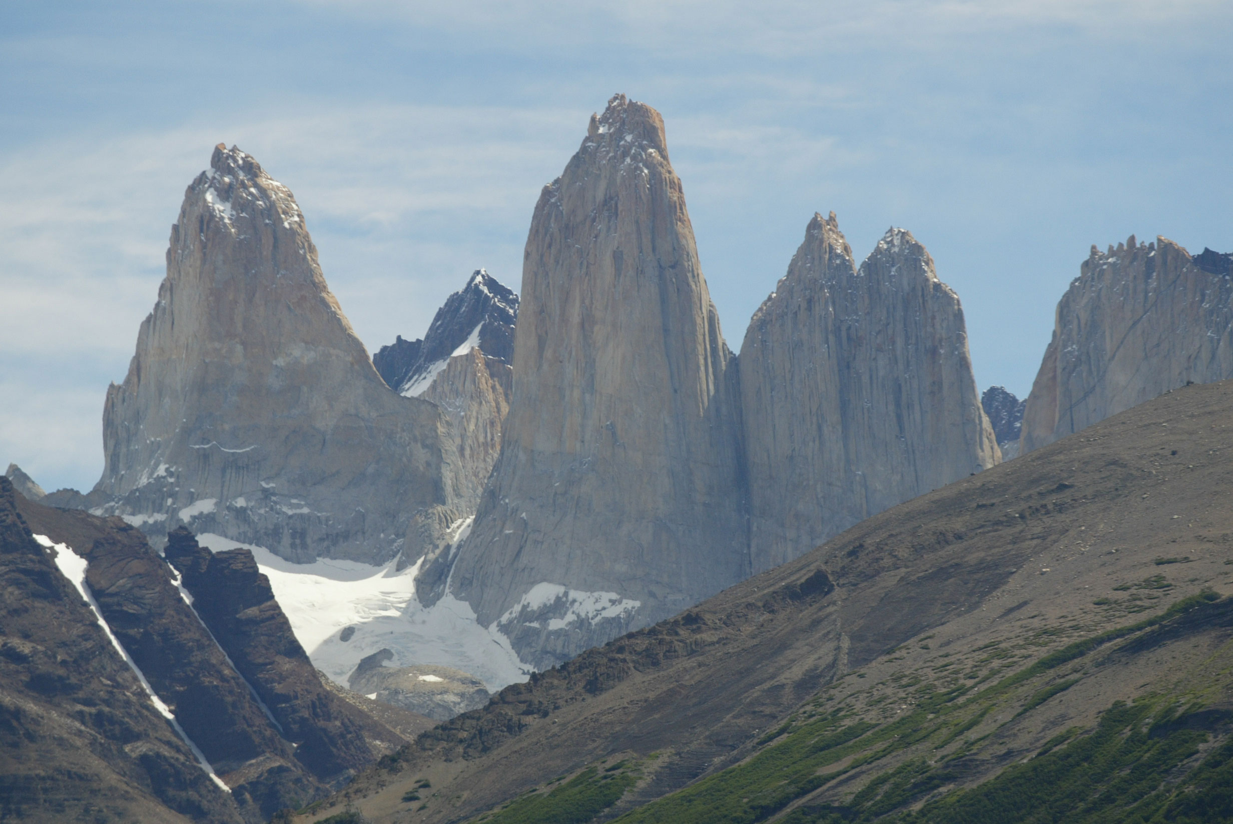 Las tres emblemáticas torres de granito se alzan majestuosas sobre una laguna glacial azul.