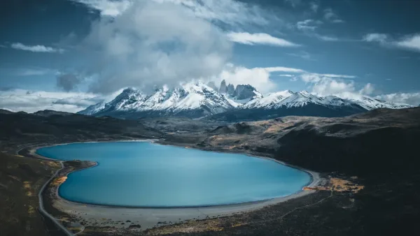 The three granite towers of the Paine Massif perfectly mirrored in the calm surface of Laguna Azul.