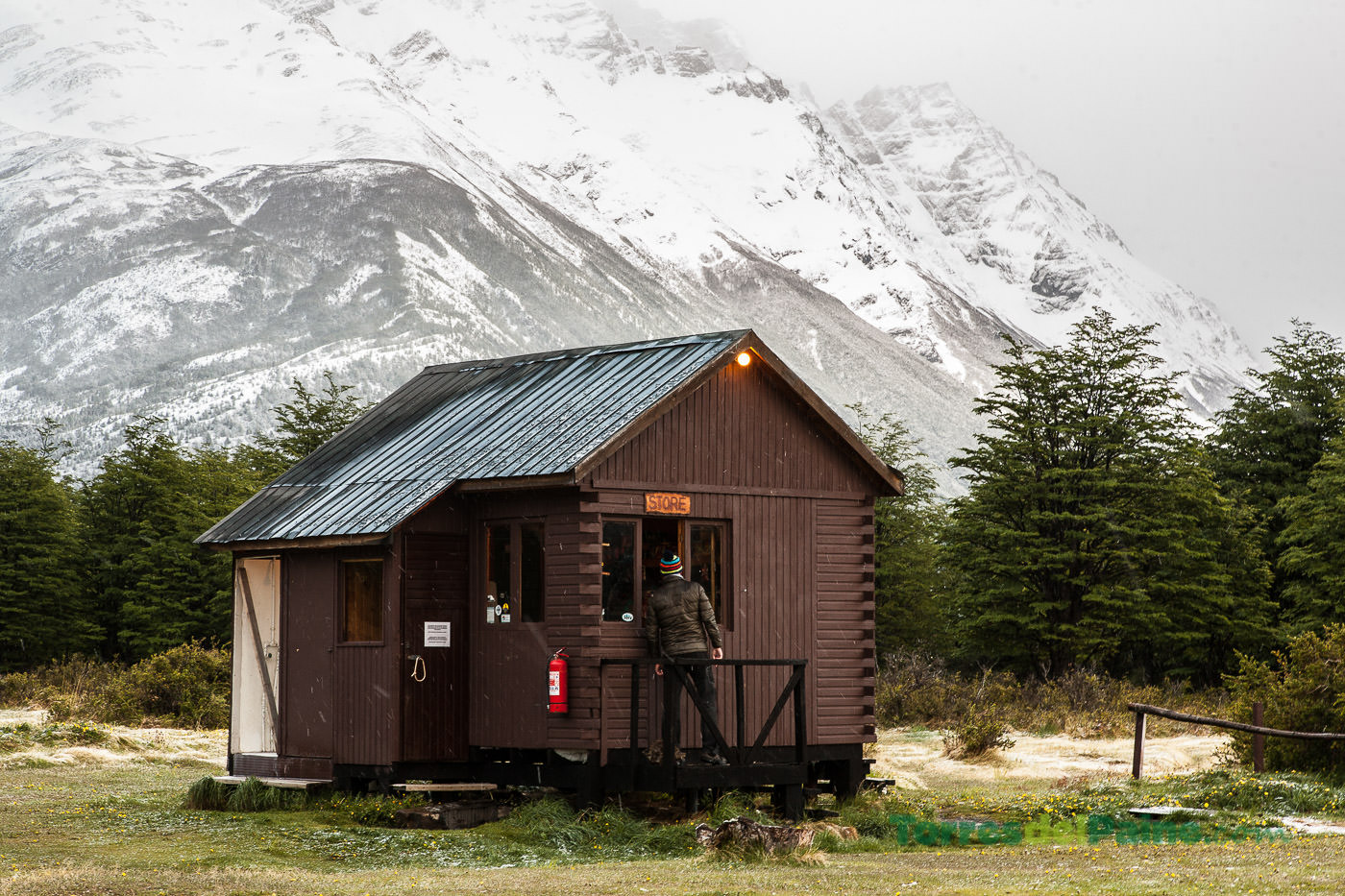 A wide view of the Dickson campground with several tents pitched near the lake's edge.