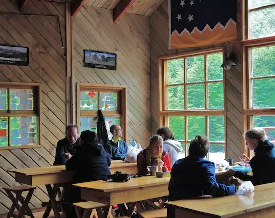 The rustic wooden exterior of Refugio El Chileno nestled in the heart of the Ascencio Valley.