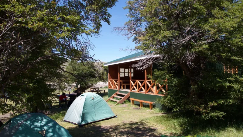 Backpackers relaxing near their tents at the tranquil Serón campground in Torres del Paine.