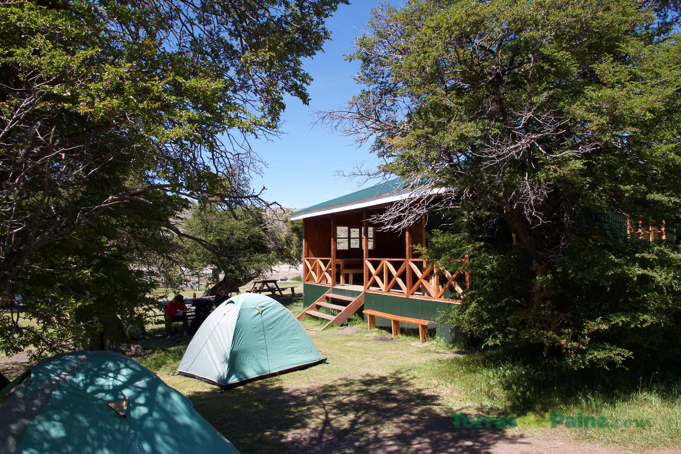 Backpackers relaxing near their tents at the tranquil Serón campground in Torres del Paine.