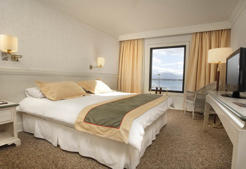 Comfortable seating area in the lobby of Hotel Costa Australis with nautical-themed decorations.