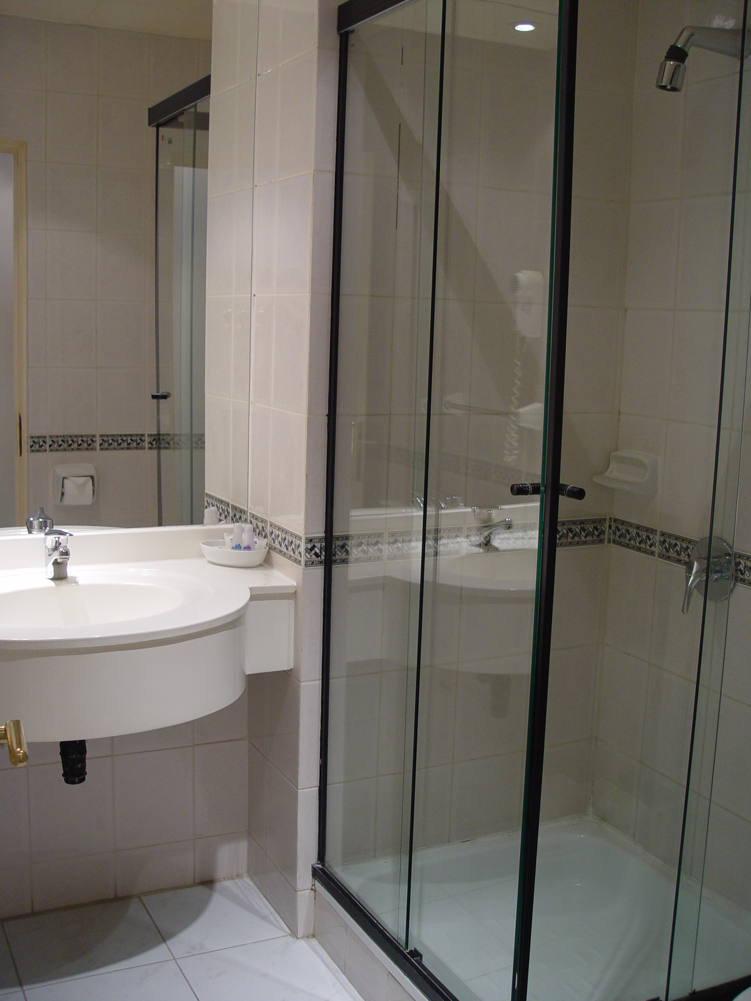 Detail of the comfortable bedding and decor in a standard room at Hotel Martin Gusinde.