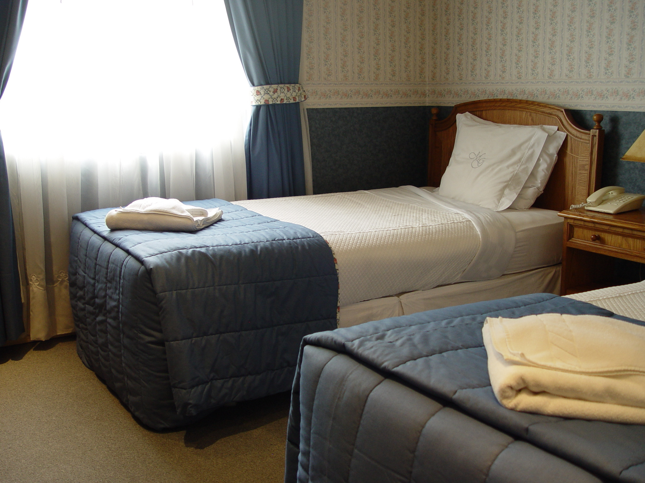 A bright, elegant breakfast room at Hotel Martin Gusinde with neatly set tables and large windows.
