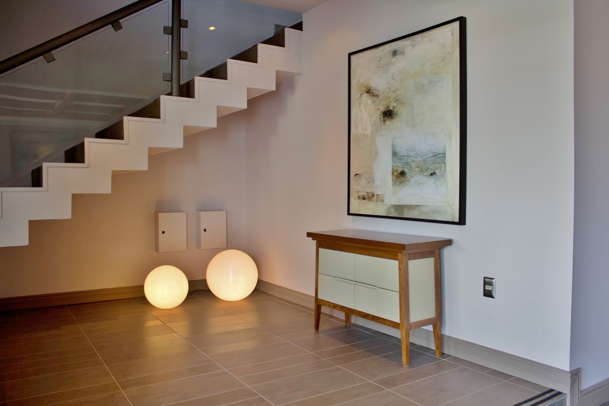 Exterior of Hotel Martin Gusinde at night, with warm lights glowing from the windows in Puerto Natales.