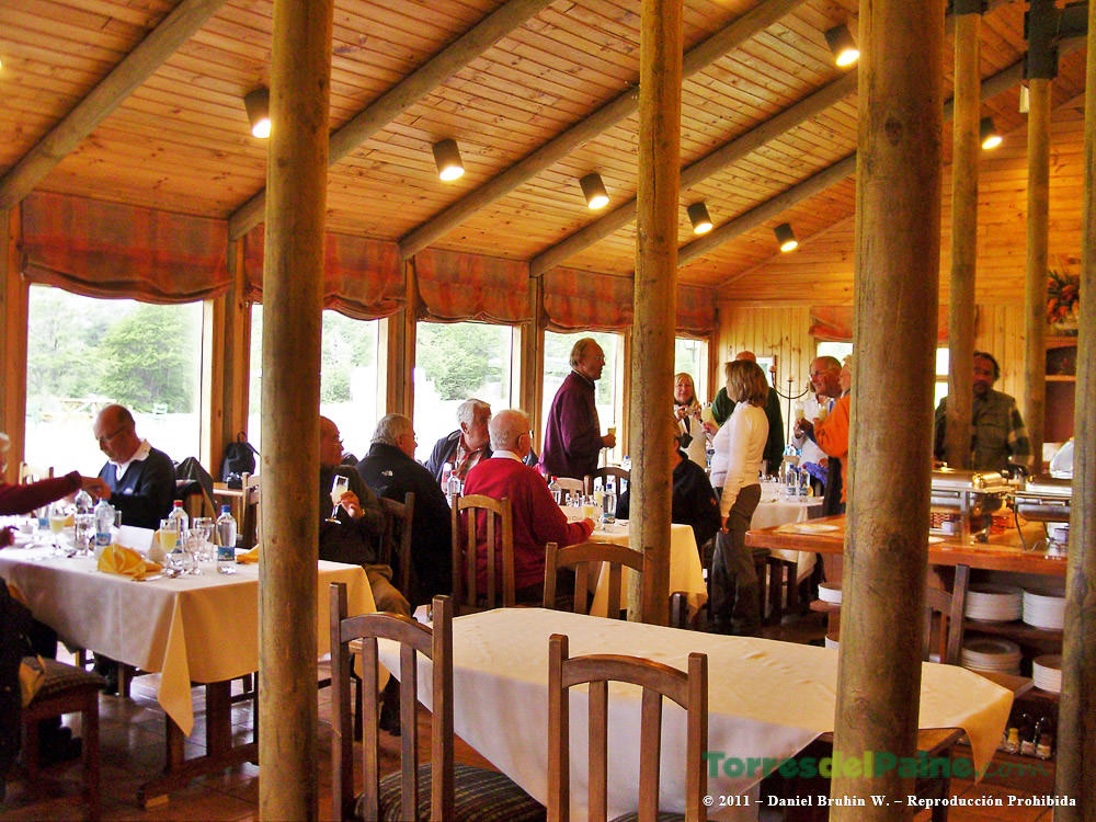 A comfortable guest room at Hotel Paine with rustic wooden decor and views of the Patagonian landscape.