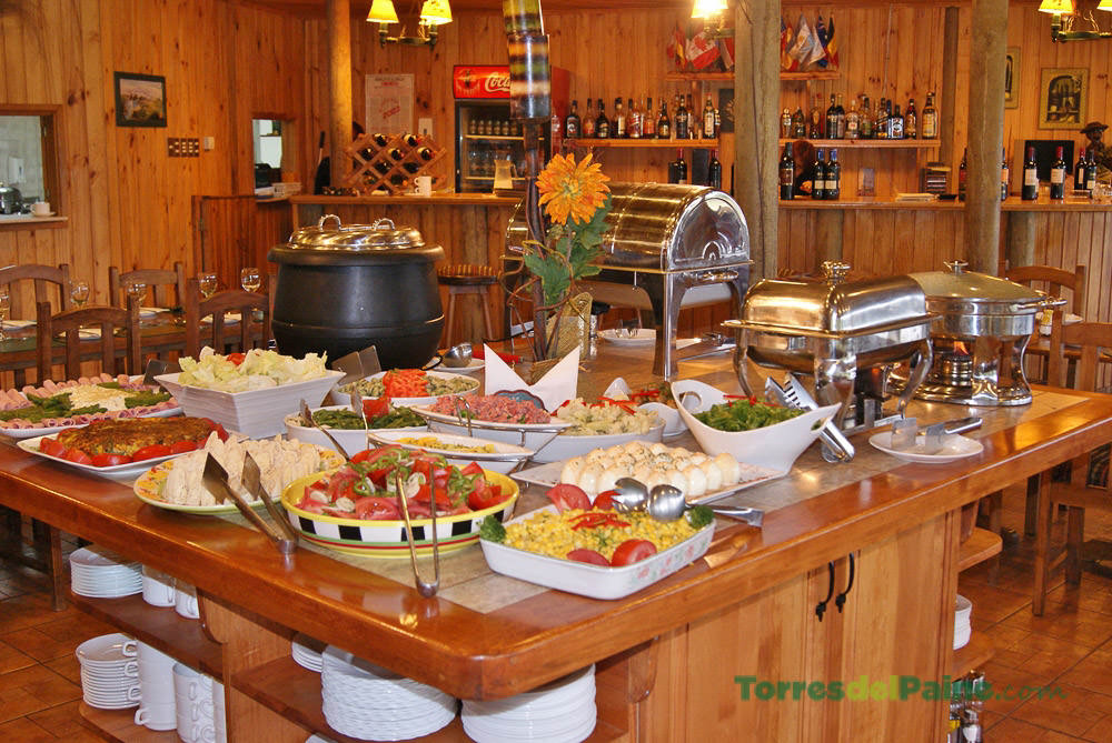 A twin bedroom at Hotel Paine featuring warm bedding and traditional Patagonian style.