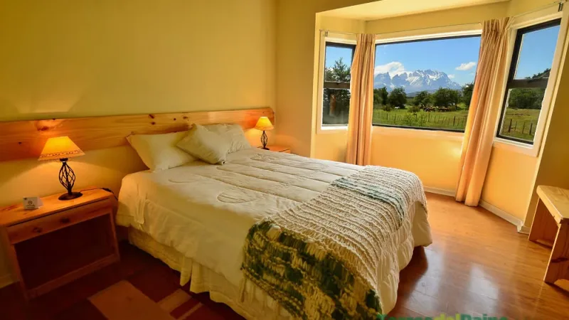 Outdoor terrace at Hotel Paine, perfect for watching the sunset over the Serrano River.