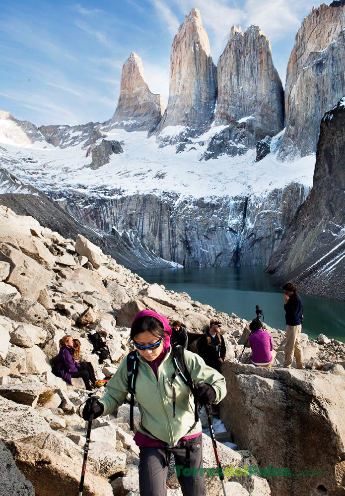 O exterior do Tierra Patagonia ao entardecer, com sua estrutura revestida de madeira brilhando contra o céu crepuscular.