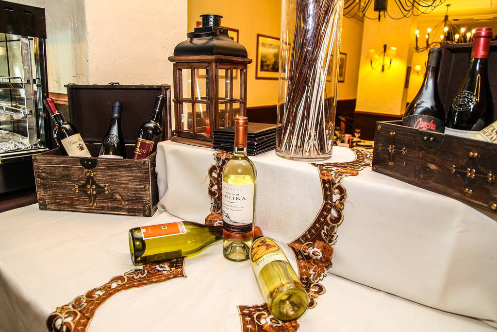 Guests dining at Restaurant Bautista with the Paine Massif visible through the floor-to-ceiling windows.