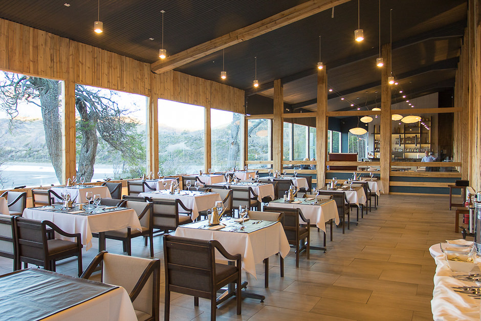 Uma vista panorâmica do exterior moderno do Restaurante Hotel Lago Grey, situado na paisagem acidentada.