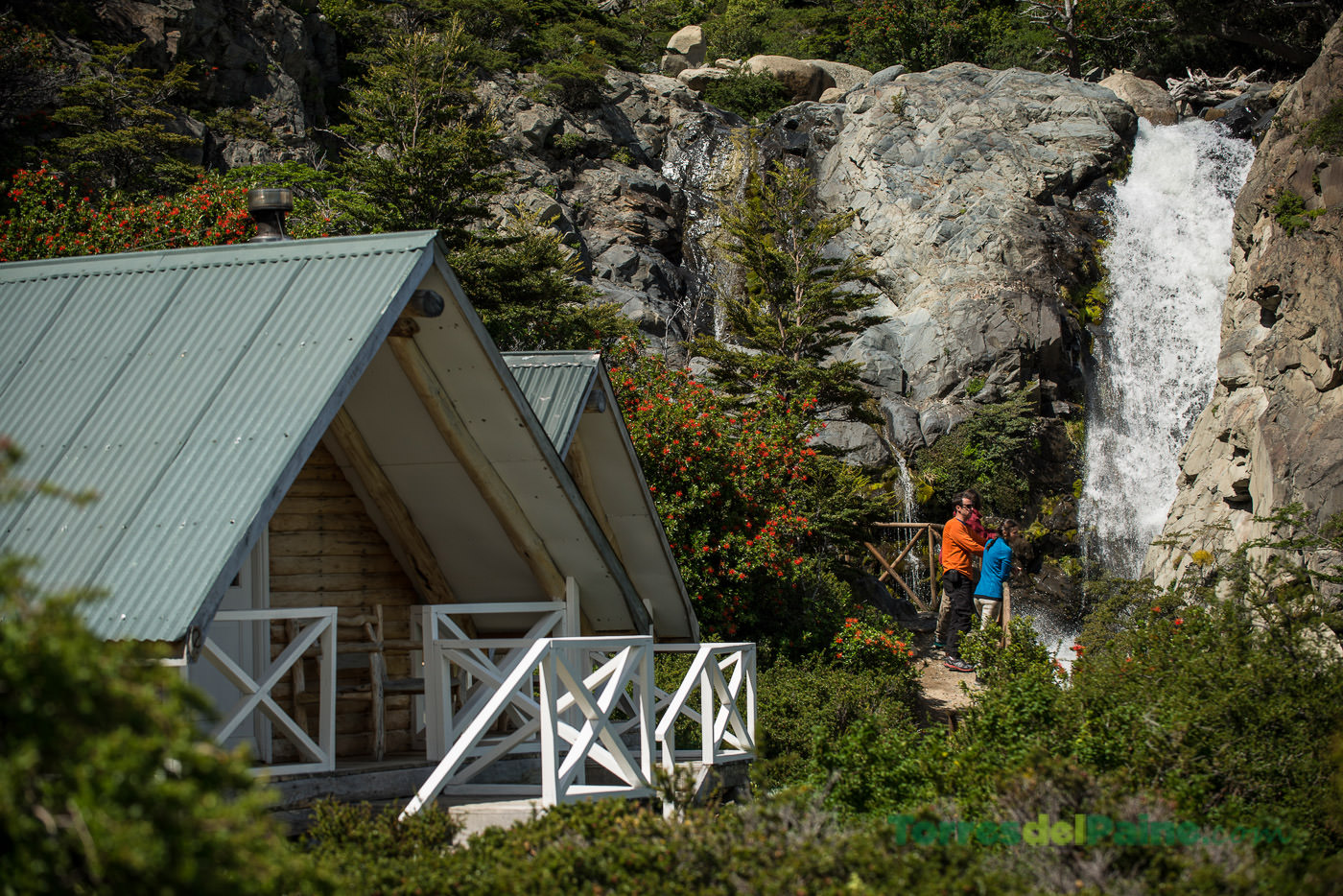 Cozy rustic wooden cabins at Cabañas Los Cuernos nestled at the base of the granite horns.