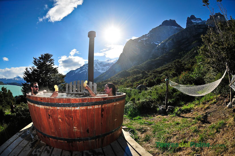 A cluster of rustic wooden cabins at Cabañas Los Cuernos at the foot of the granite mountains.