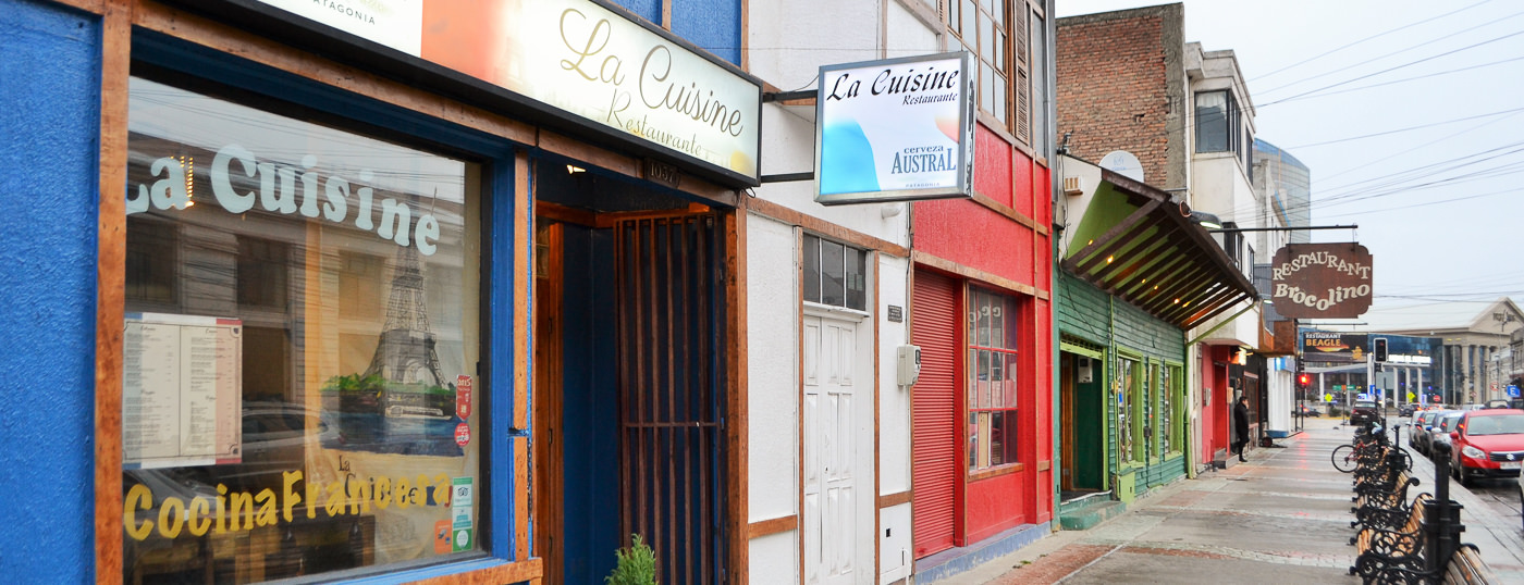 The welcoming entrance and storefront of La Cuisine restaurant in Puerto Natales.