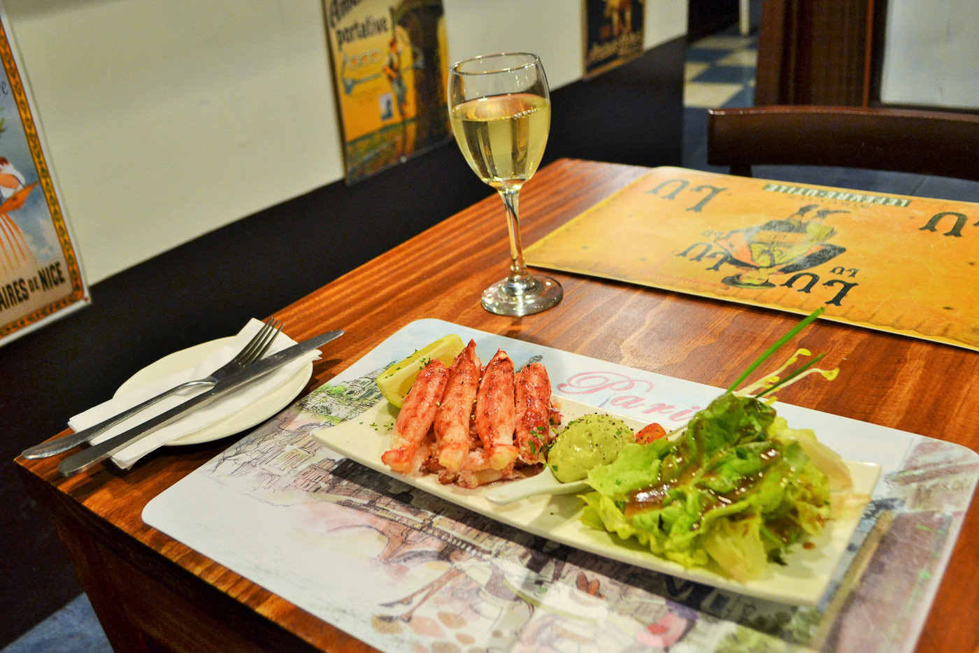 Tables set with white linens inside the rustic-chic dining space of La Cuisine.