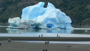 Pasajeros en la cubierta de un barco contemplando el majestuoso glaciar Grey.