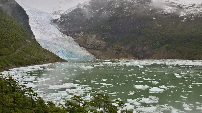 A panoramic shot of the Serrano Glacier calving into the water at the end of the fjord.