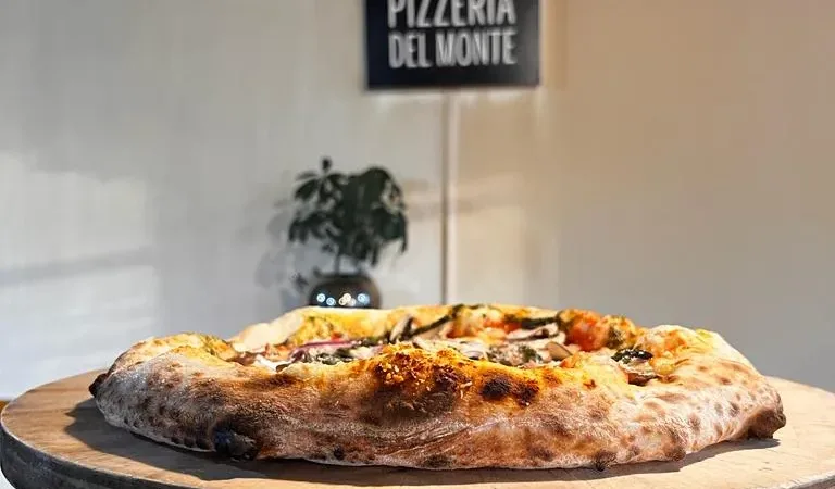 Exterior de la Pizzería del Monte, donde se aprecia su encantadora fachada de estilo patagónico.