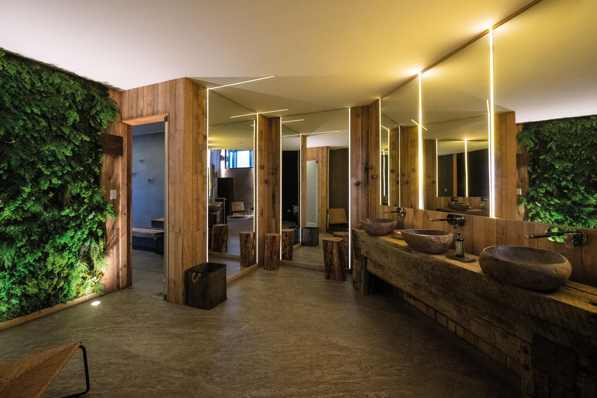 A well-appointed guest room with warm lighting and a large window facing the mountains.