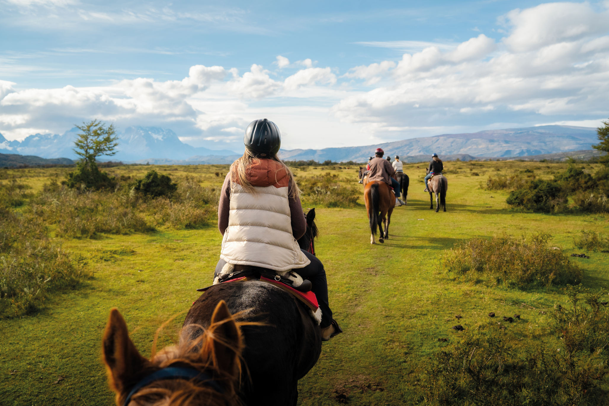 A wide panoramic view of the Serrano river valley under a stormy Patagonian sky.