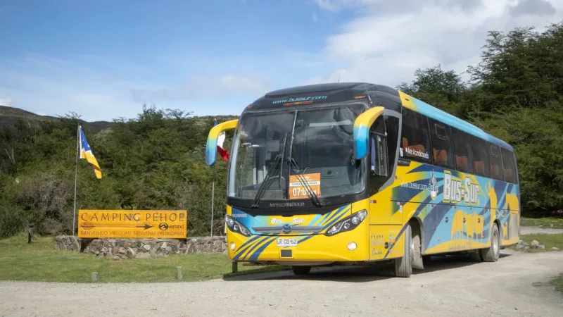 The bus stop area at Laguna Amarga with a Bus Sur coach in the foreground.