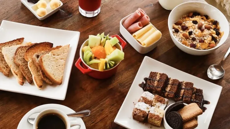 A healthy breakfast tray with fresh juice, coffee, and pastries at a local lodge.