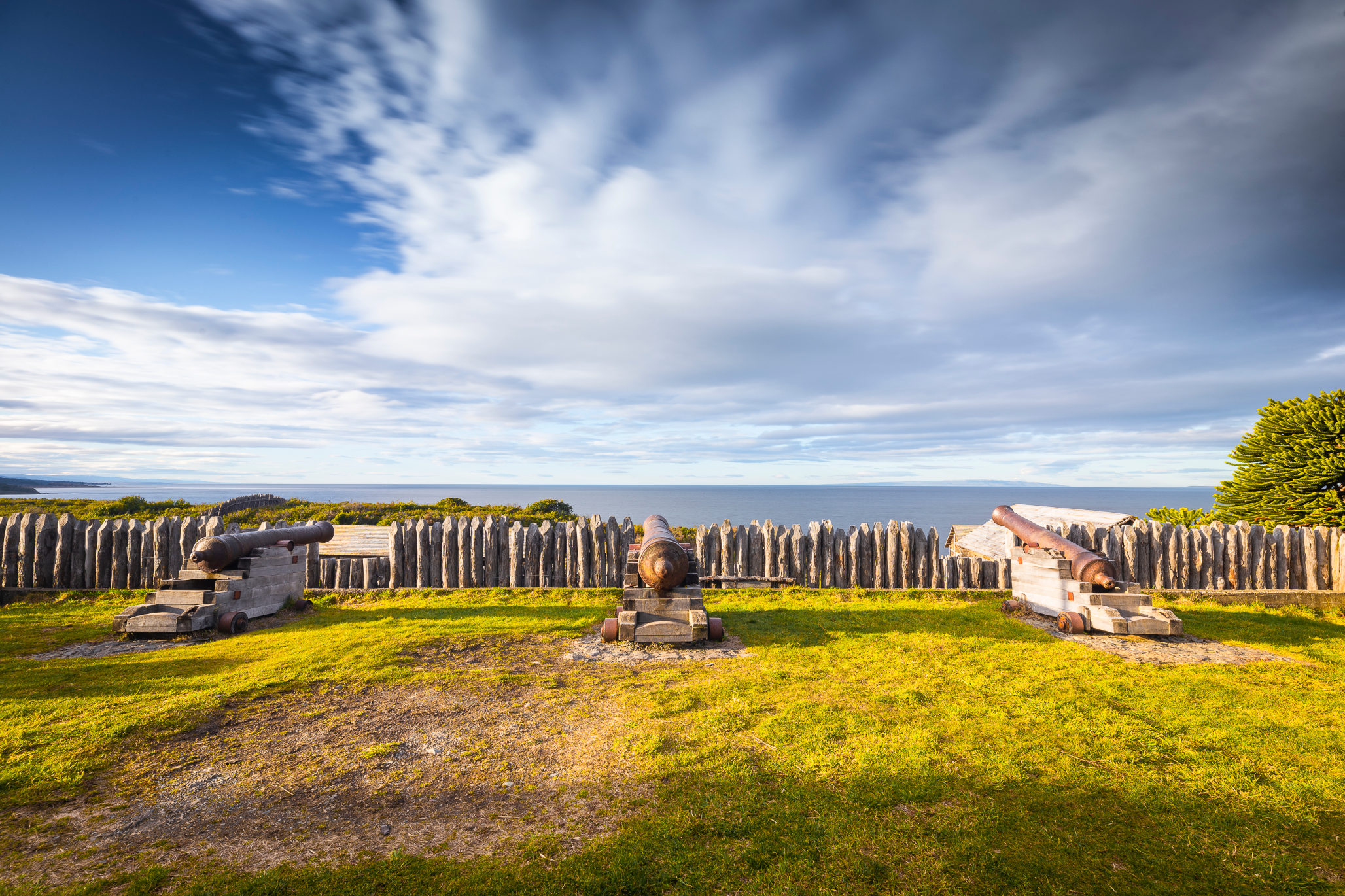 Old iron cannons positioned on the defensive walls of Fuerte Bulnes.