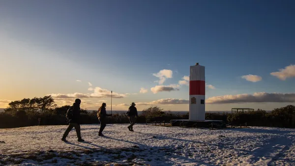 The small red and white lighthouse named after Bernardo O'Higgins on the rocky coast.