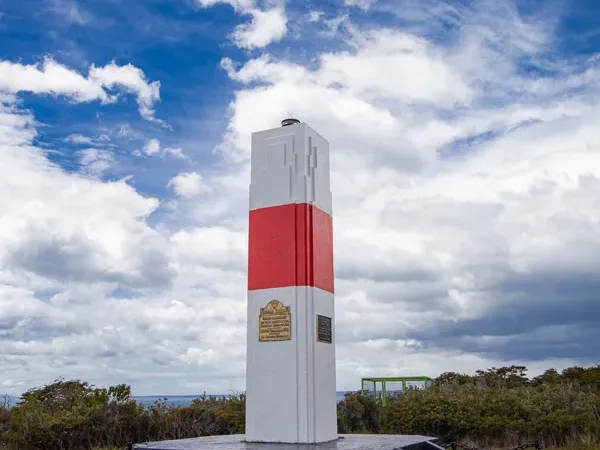 A distant view of the lighthouse standing as a sentinel over the strait's waters.