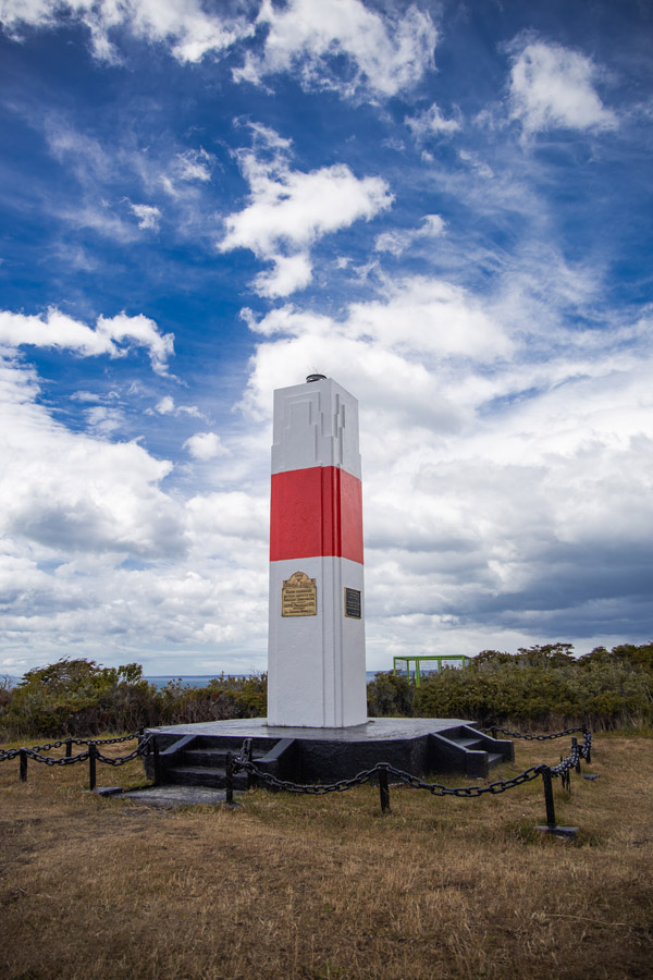 A distant view of the lighthouse standing as a sentinel over the strait's waters.